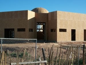 The masjid building with bare, unpainted walls