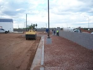 A new curb and graded ground beside the lot