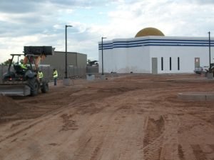 Equipment working the lot in front of the masjid